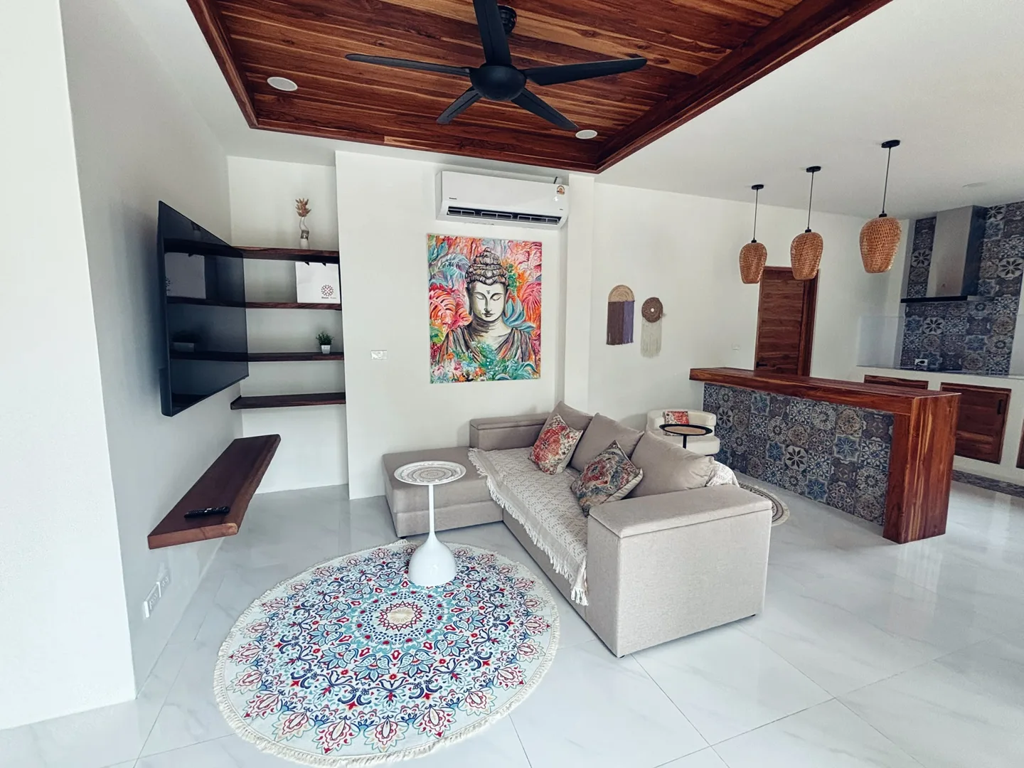 Open living room with timber ceiling, sofa and kitchen